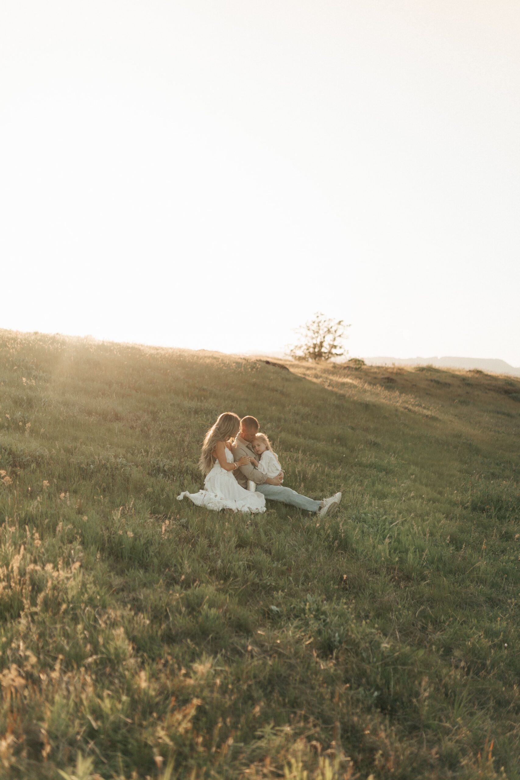 Family on grassy hillside